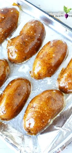 the best large roasted melting potatoes are on display in a glass baking dish with text overlay