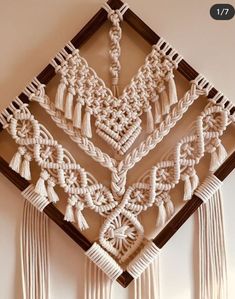 the wall hanging is made with white yarn