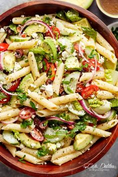 a bowl filled with pasta salad and dressing