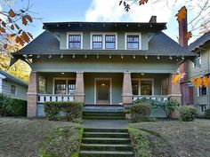 a house that has steps leading to the front door and stairs up to the second floor