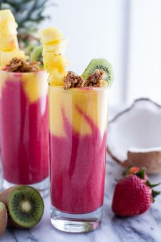 two glasses filled with fruit smoothie next to sliced kiwis