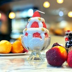 an ice cream sundae with strawberries and oranges