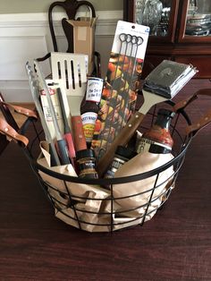 a basket filled with cooking utensils on top of a wooden table