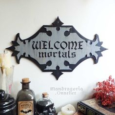 a welcome sign is mounted on the wall next to some liquor bottles and other items