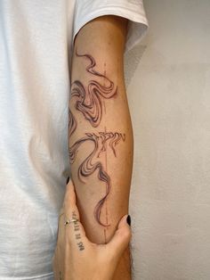 a person with a tattoo on their arm