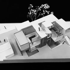 an architectural model of a house with people walking around