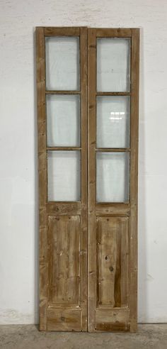 an old pair of wooden doors with glass panels