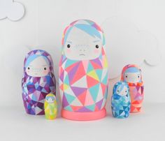 three colorful nesting dolls sitting next to each other