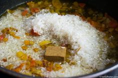 rice and vegetables being cooked in a pot