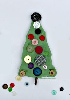 a christmas tree made out of buttons on a white surface