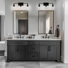 a large bathroom with two sinks and mirrors