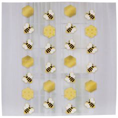 bees and honeycombs are hanging on a white curtain with gold foiled decorations