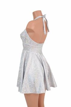 "This item is made to order, please read all the way through the listing before purchasing! This flowy dress is made of silver on white shattered glass holographic spandex. The halter top is darted and ties behind the neck, the hemline is circle cut. Length: 17\" measured from the waist to the hemline. We can create this dress from any other fabric in our shop, just ask! Womens Sizing (See below for instructions on where measurements should be taken) XXS: Bust 29\"-30\" / Waist 22\"-23\" / Hips Silver Backless Dresses For Party Season, Silver Backless Dress For Party Season, Silver Glitter Mini Dress For Summer, Silver Sleeveless Dress For Homecoming, Silver Fitted Backless Dress, Elegant Silver Dress For Costume Party, Silver Dresses For Summer Homecoming, Silver Summer Homecoming Dresses, Silver Sleeveless Glitter Dress