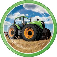 a green and yellow plate with a tractor in the middle of it on a field