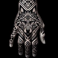 a person's hand with tattoos on it and a wolf head in the middle