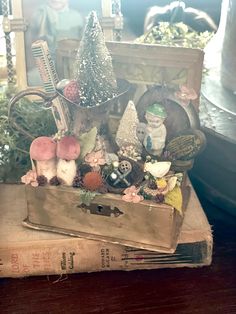 a wooden box filled with lots of different types of items on top of a table