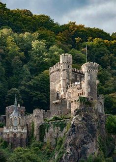 an old castle sitting on top of a mountain