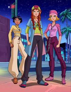 three young women standing next to each other in front of a city street at night