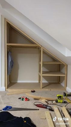 an attic with shelves and tools on the floor