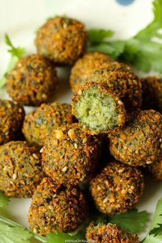 a white plate topped with meatballs covered in seasoning