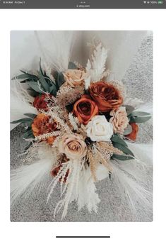 an image of flowers and feathers on the web page for wedding photographer's website