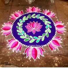 a blue and pink flower design on the ground