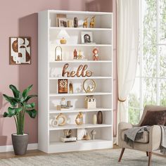 a living room with a white bookcase and pink walls