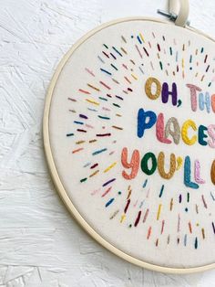 an embroidered wall hanging with the words oh the places you'll go on it