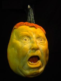 a carved pumpkin with an evil face on it's head