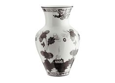 a black and white vase with flowers on the bottom is sitting in front of a white background