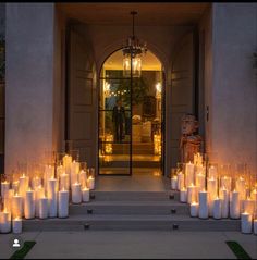 many candles are lit in front of an entrance