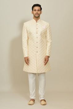 Cream sherwani featuring floral motif thread and sequin work all over. Paired with a white churidar. - Aza Fashions Off White Sherwani With Zari Work For Diwali, Off White Zari Work Sherwani For Diwali, Fitted Off White Sherwani With Chikankari Embroidery, Fitted Off-white Sherwani With Chikankari Embroidery, Bollywood Style Off White Bandhgala With Zari Work, Off White Fitted Churidar For Wedding, Fitted Off White Kurta With Zari Work, Off White Fitted Sherwani With Cutdana, Off White Fitted Bandhgala Straight Kurta