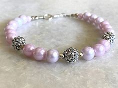 a pink beaded bracelet with silver beads