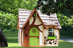 a tree house with a green door and window