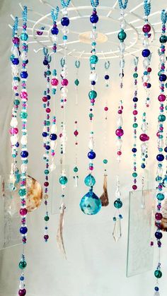 an assortment of colorful beads hanging from a ceiling