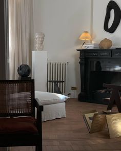 a living room filled with furniture and a fire place in front of a wall mounted fireplace