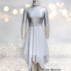 a white dress with silver sequins is on display in front of a glitter background