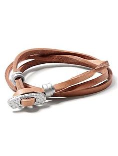 a brown leather bracelet with silver clasps