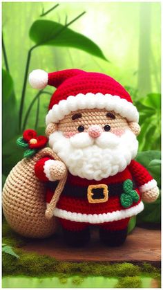 a crocheted santa clause doll sitting on top of a wooden table next to green plants