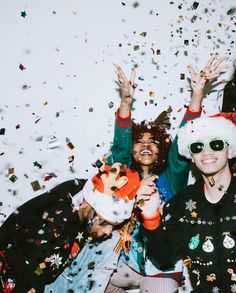 group of young people celebrating with confetti and streamers in the air on white background