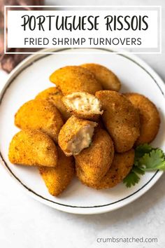 fried shrimp turnovers on a white plate with parsley garnish in the middle