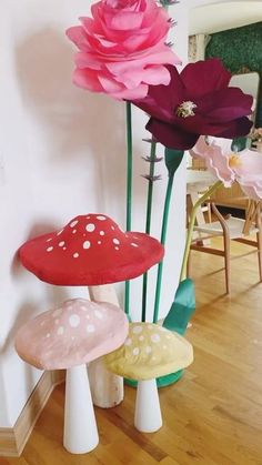 several different colored mushrooms and flowers in a room