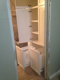 an open refrigerator with its door wide open and the freezer doors closed on both sides