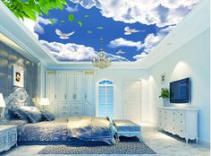 a bedroom with blue sky and white clouds painted on the ceiling is pictured in this image