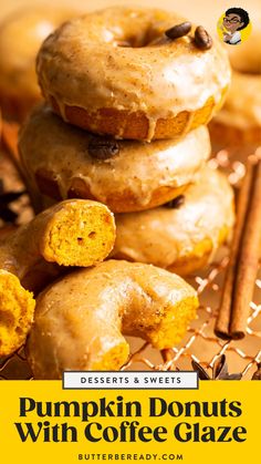 a pile of doughnuts sitting on top of a cooling rack next to cinnamon sticks