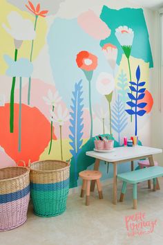 a child's playroom with colorful flowers painted on the wall