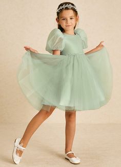 Blondie features a playful A-line design in airy tulle, complete with a charming scoop neckline and delicate sleeves. Adorned with sparkling beading, this dress adds a touch of whimsy and elegance, making it perfect for a magical celebration. Sage Flower Girl Dress, Cottagecore Tea, Military Ball Dresses, Dusty Sage, Sage Dress, Special Event Dresses, Lace Bride, Tulle Flower Girl, Flower Girl Dresses Tulle