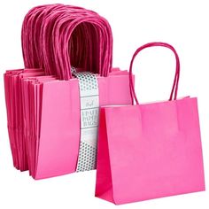 pink shopping bags are stacked on top of each other, with one bag in the middle