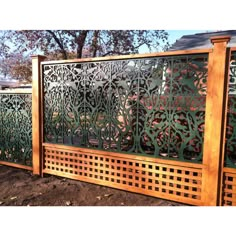 a wooden fence with intricate designs on it