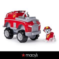 a toy fire truck with a dog next to it on a white background and the caption says macy's